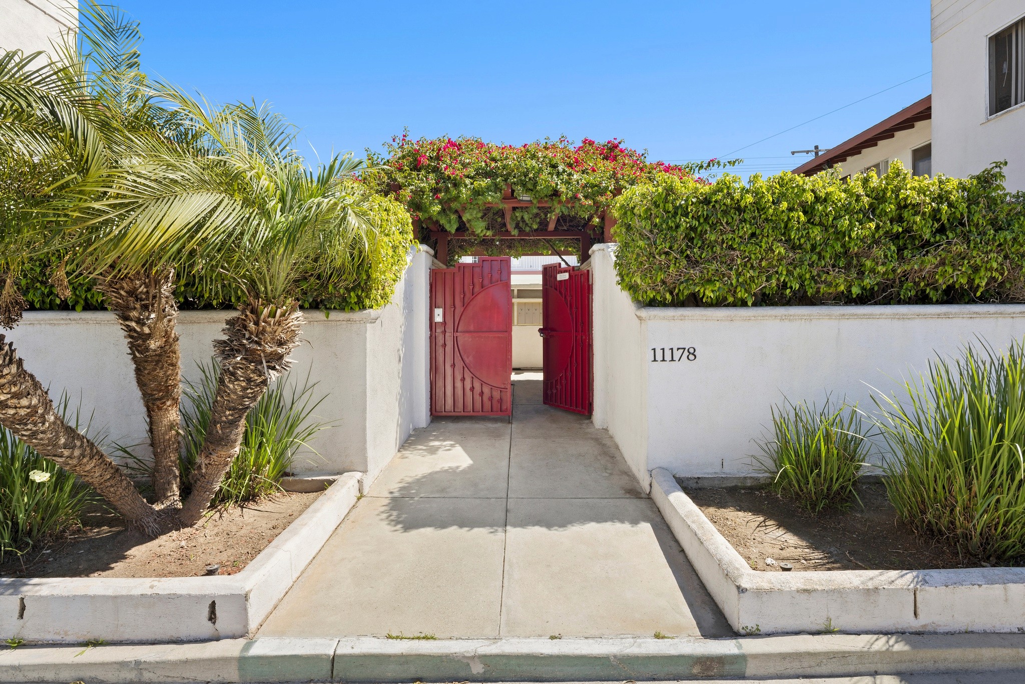 Front entry walkway with gated access and landscaped courtyard at 11178 Culver Blvd.