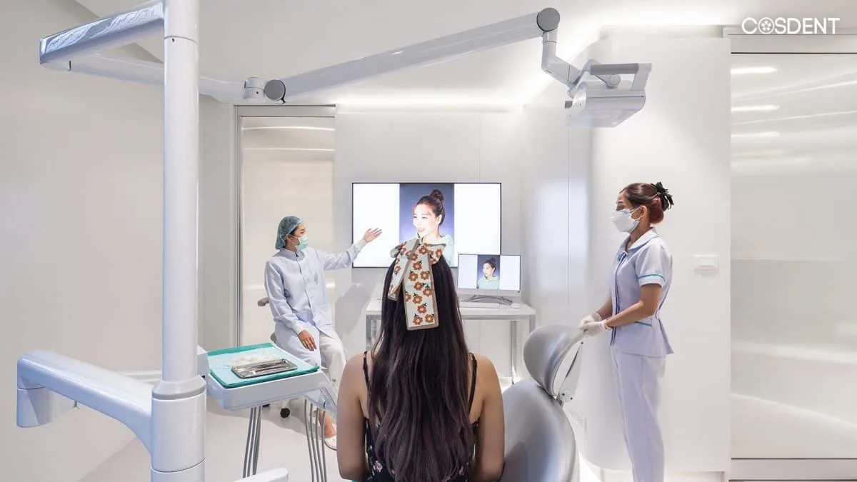 Dentist consulting with patient before dental cleaning and Airflow stain removal at COSDENT