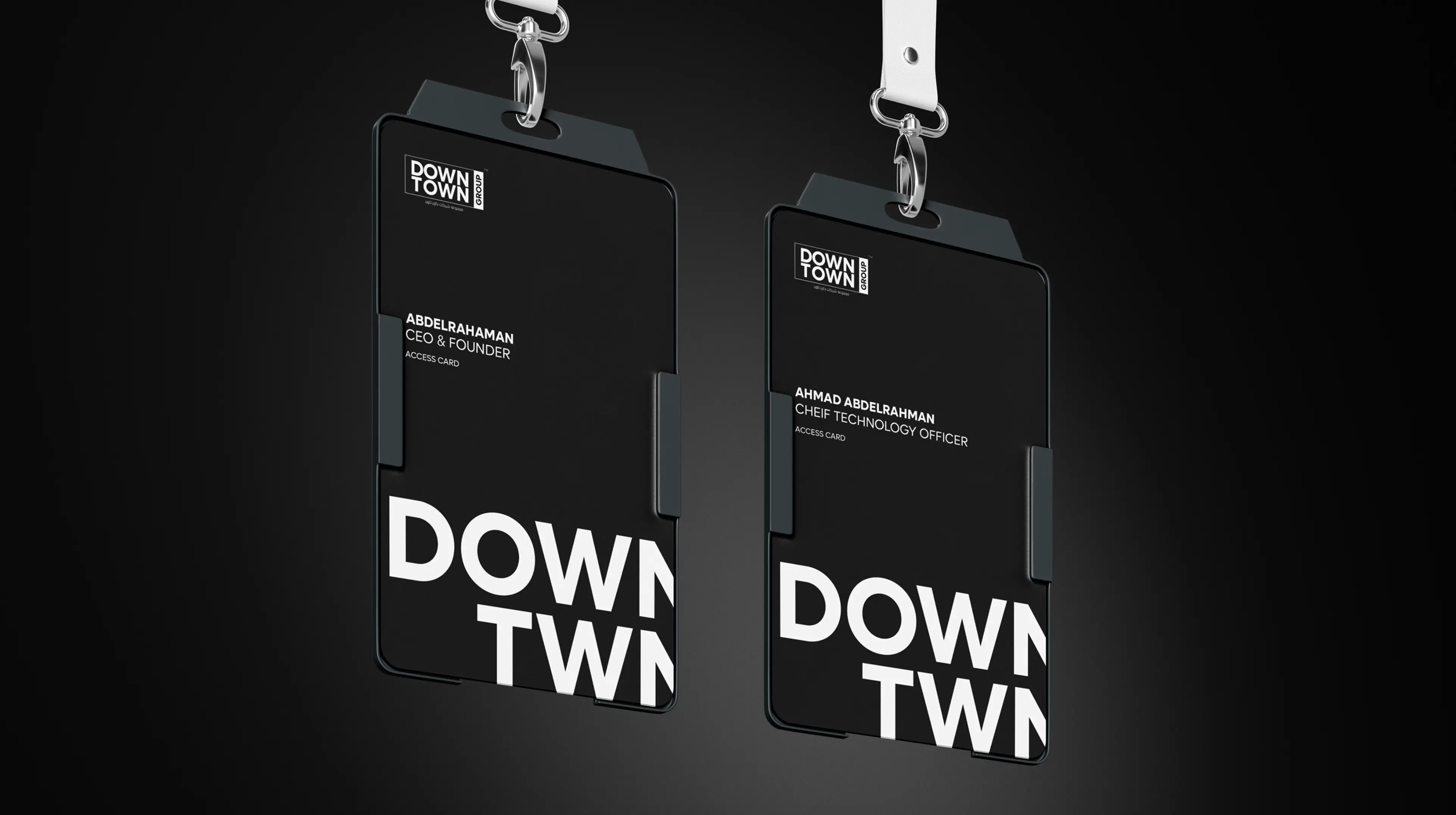 Downtown Group branded employee ID badges and lanyards for CEO and CTO showing corporate identity system in black and white