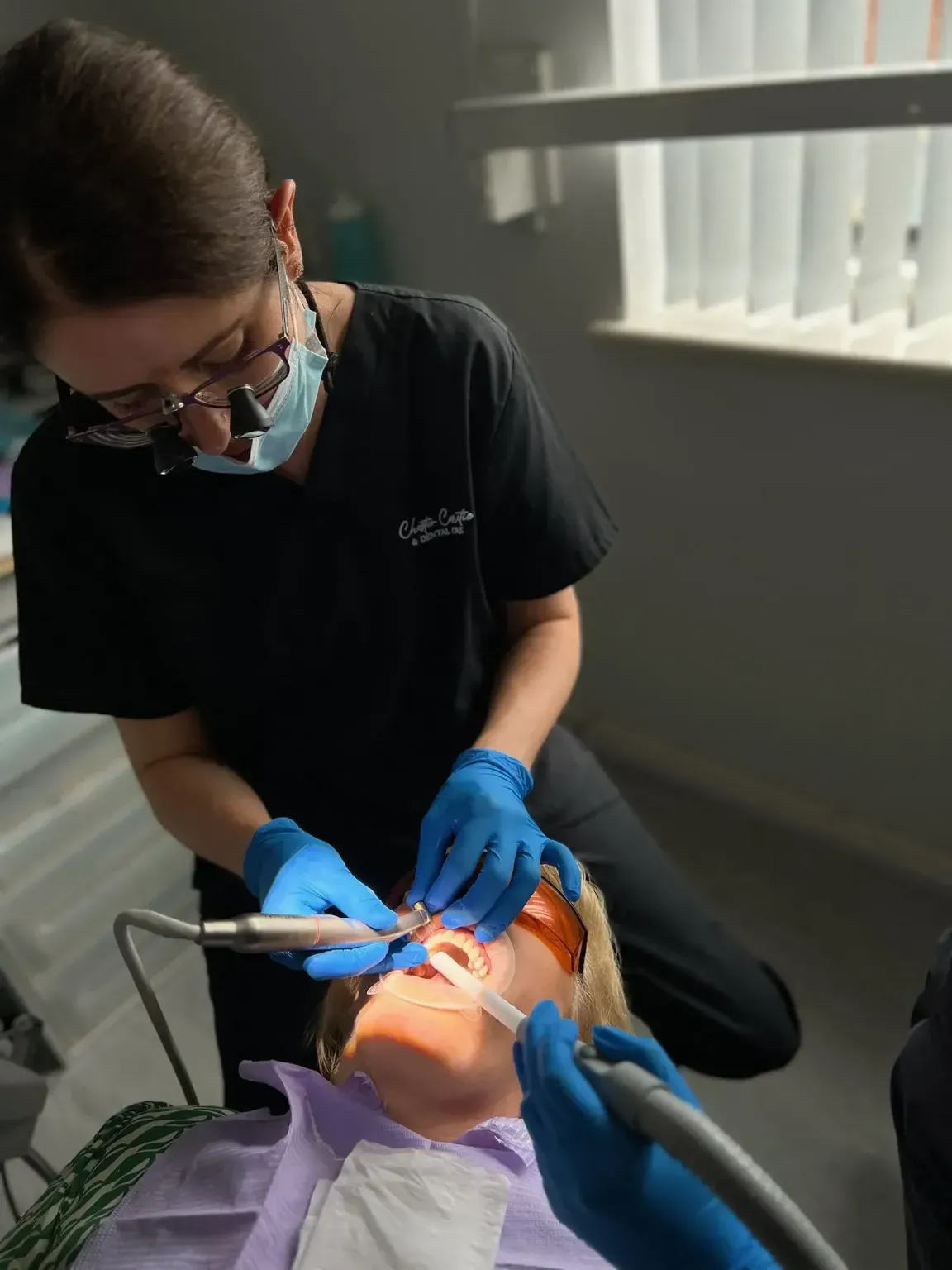 Dr April in surgery, to do some dental work on a patient.