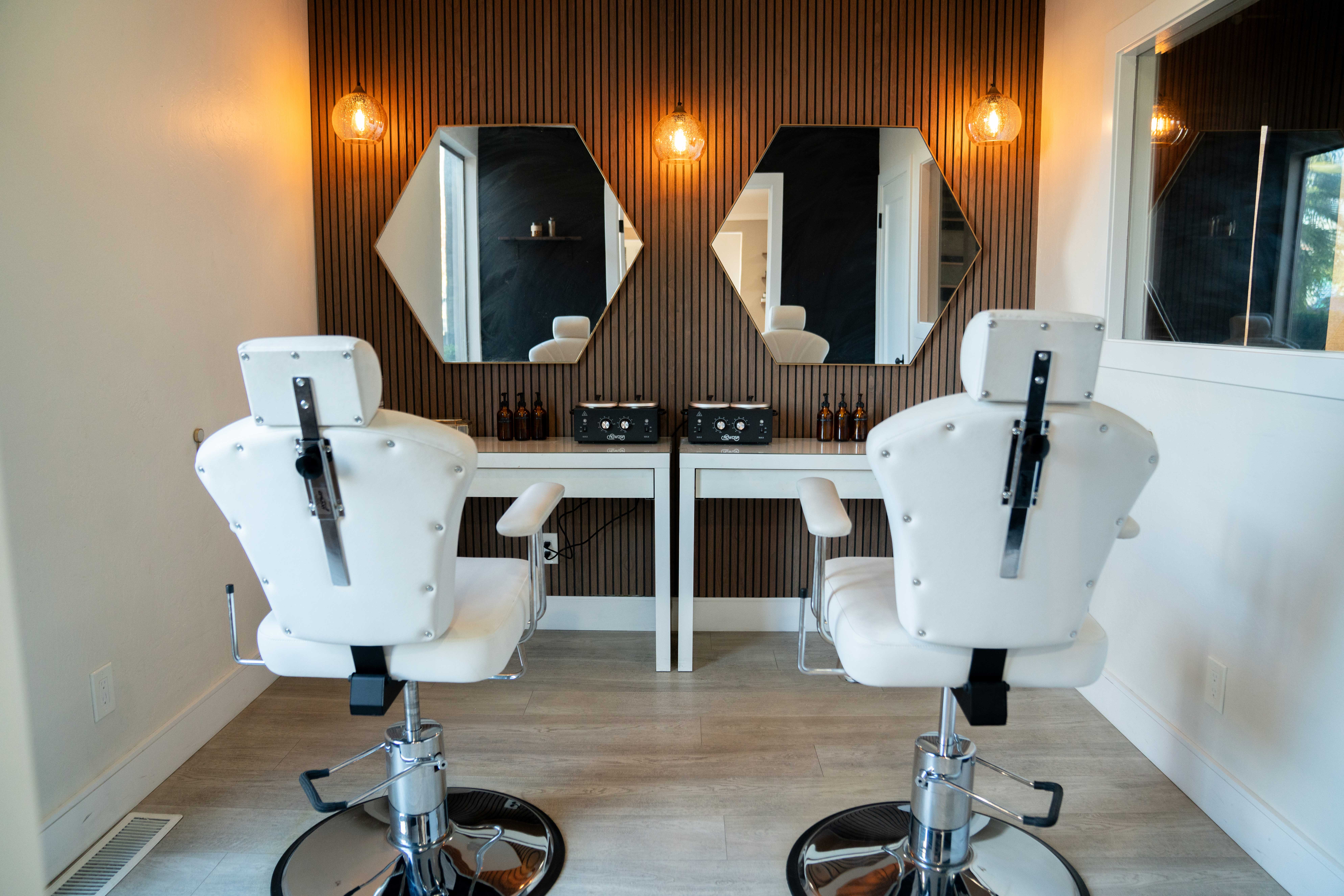 Four diverse professionals collaboratively working on a laptop, with one person pointing at the screen while others observe.