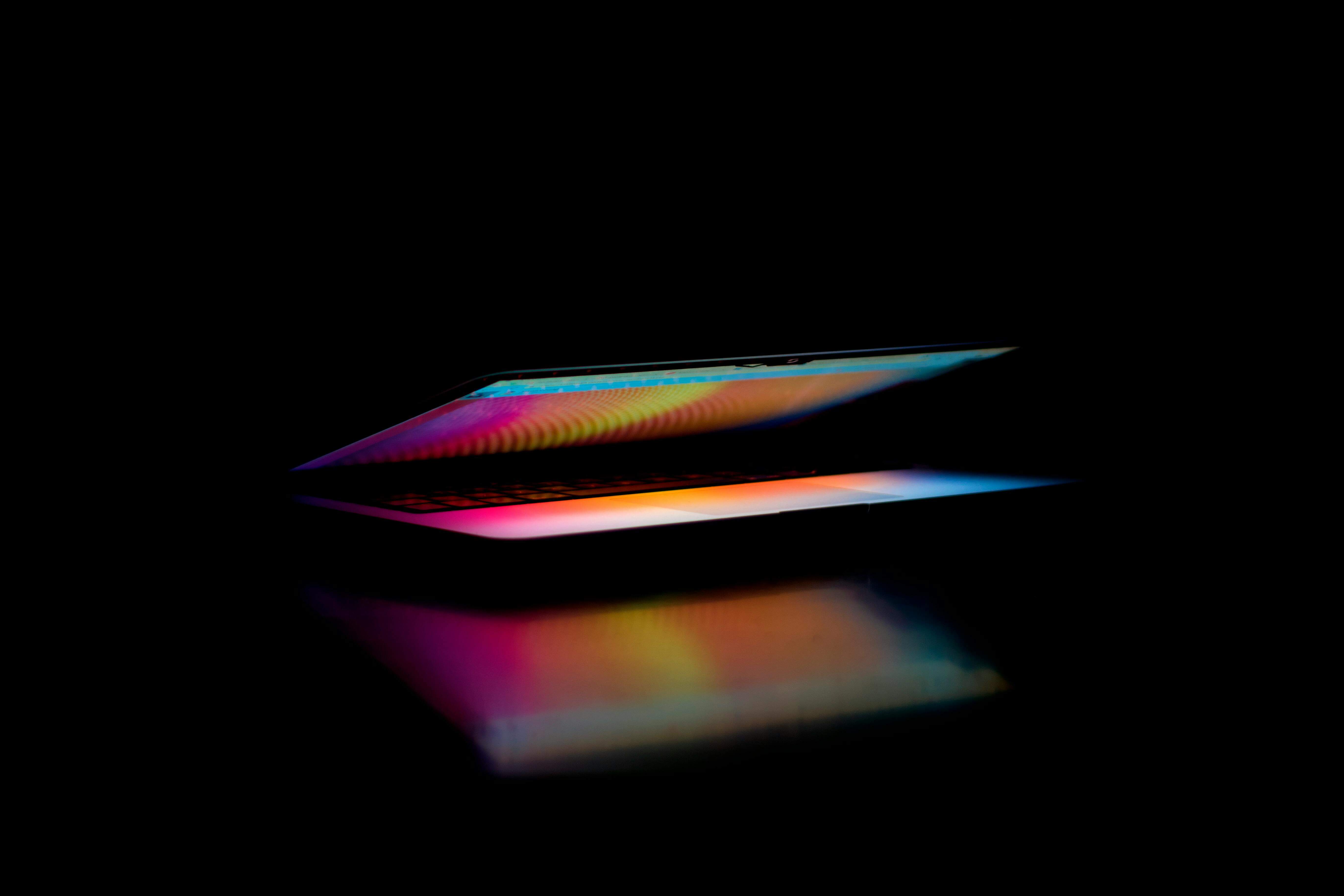 Partially open laptop with a colorful display.
