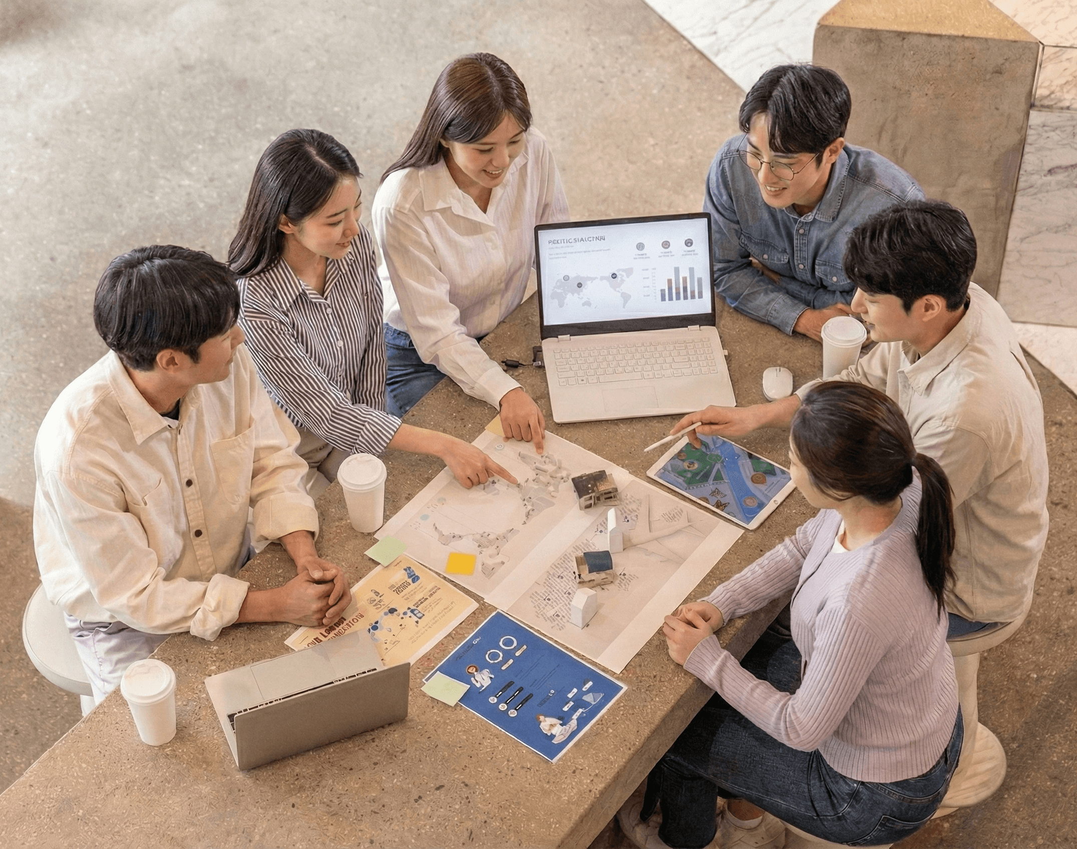 Three people sitting on a couch in a room looking at mobile devices