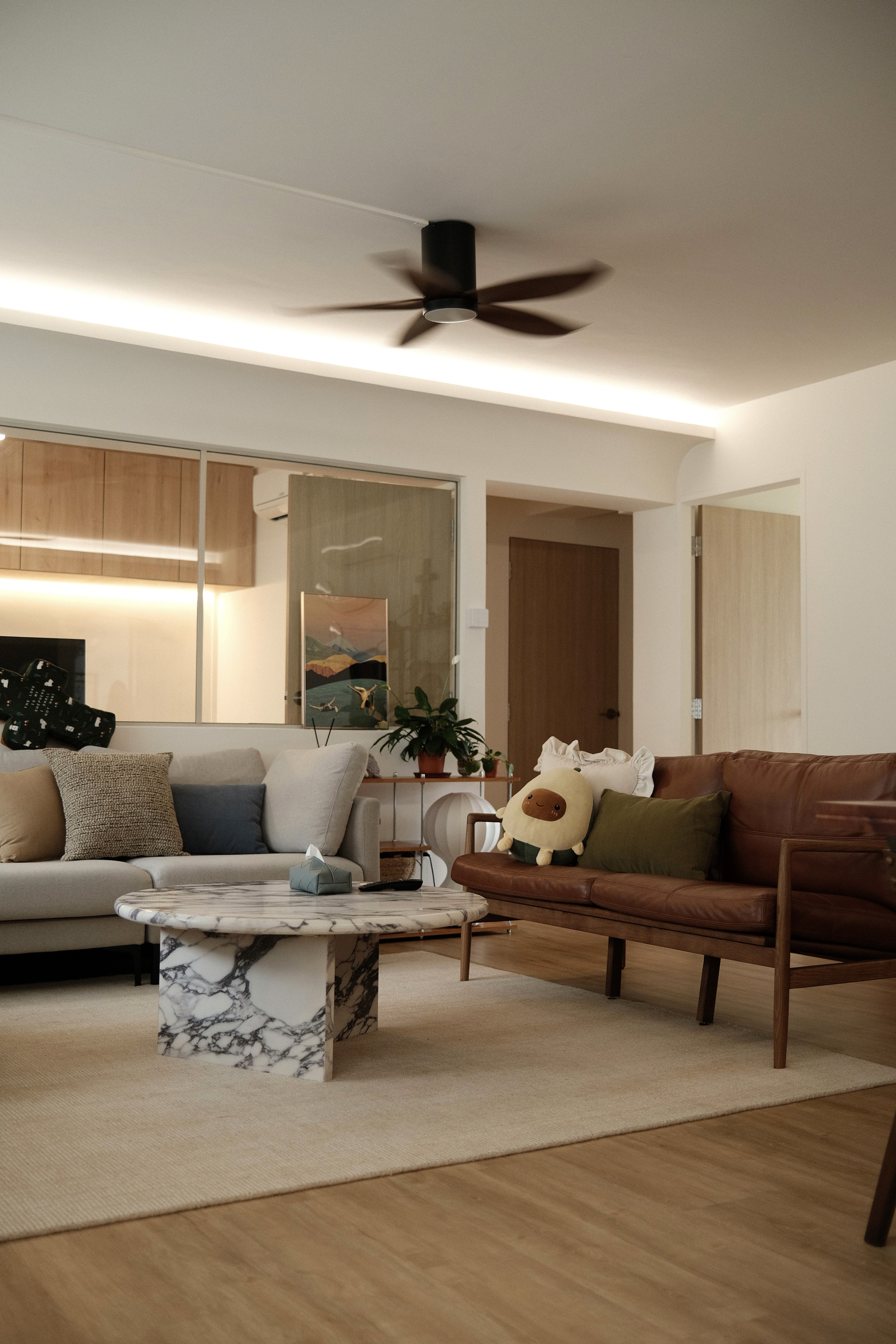 A relaxed living area layered with warm timber, soft upholstery, and natural light, designed for comfort and everyday gathering.