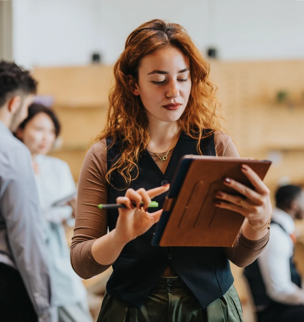 A dark cylindrical object on a wooden bar, with softly glowing lights in the blurred background.