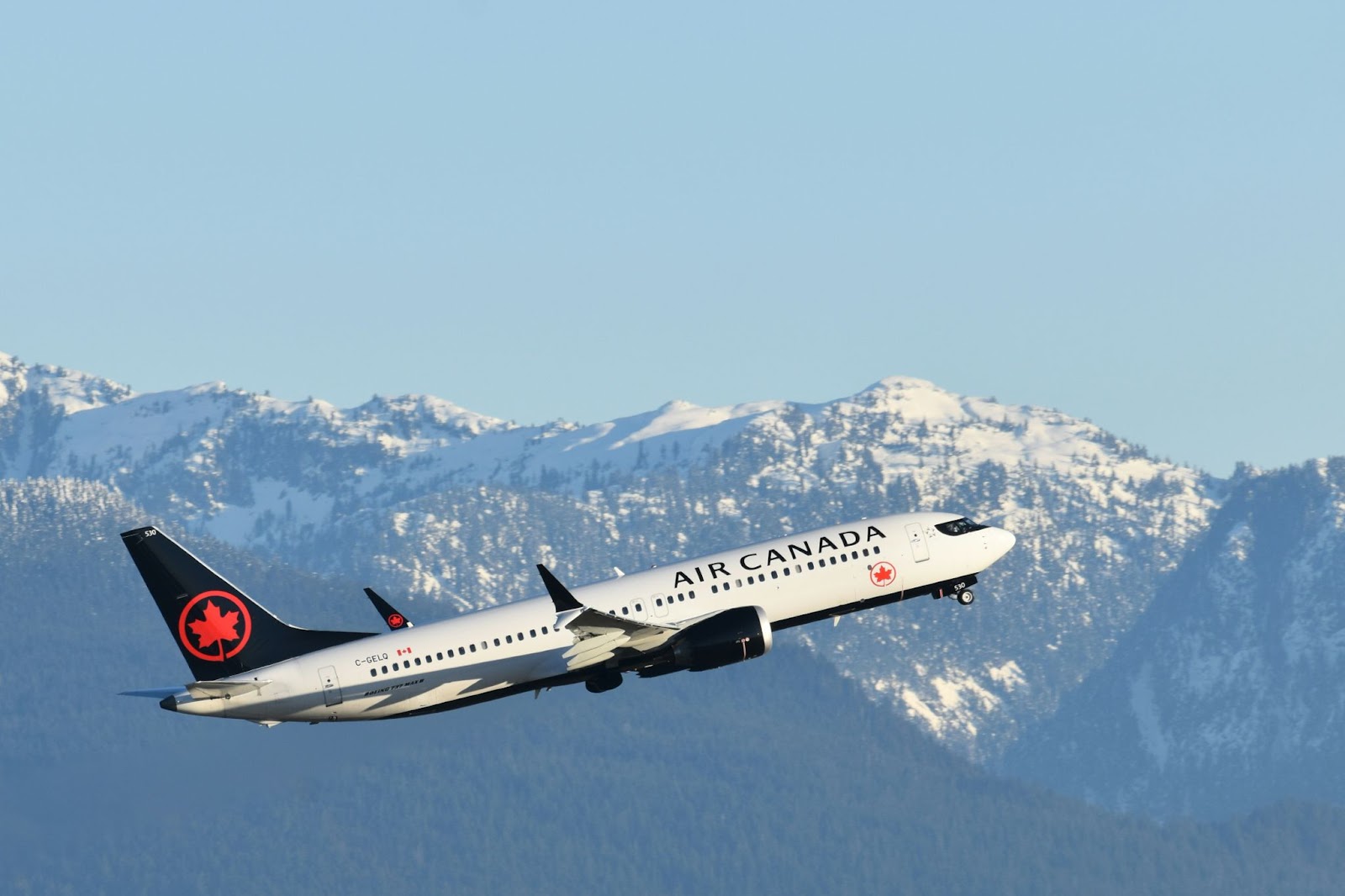 An Air Canada plane flying through the mountains