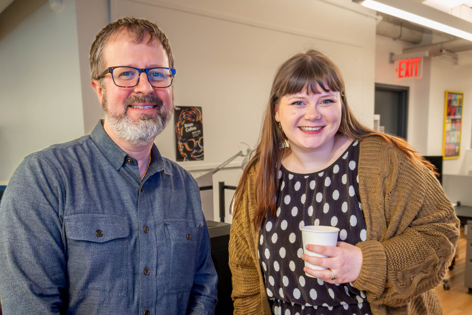 two panelists for the Thesis Defense looking at camera