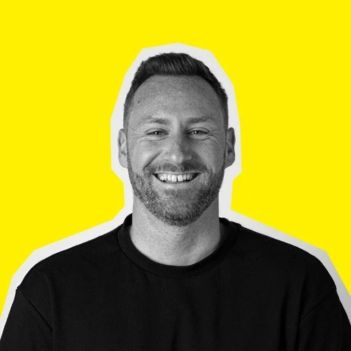 Profile portrait of a man in a white shirt against a light background