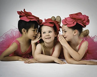 3 tiny tots having fun in front of the camera