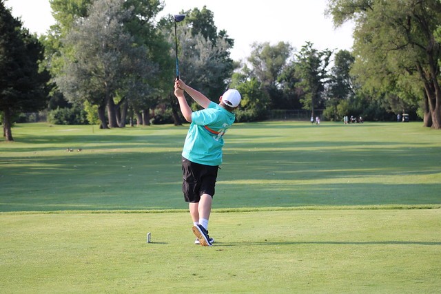 Jax finishing a swing with his putter.