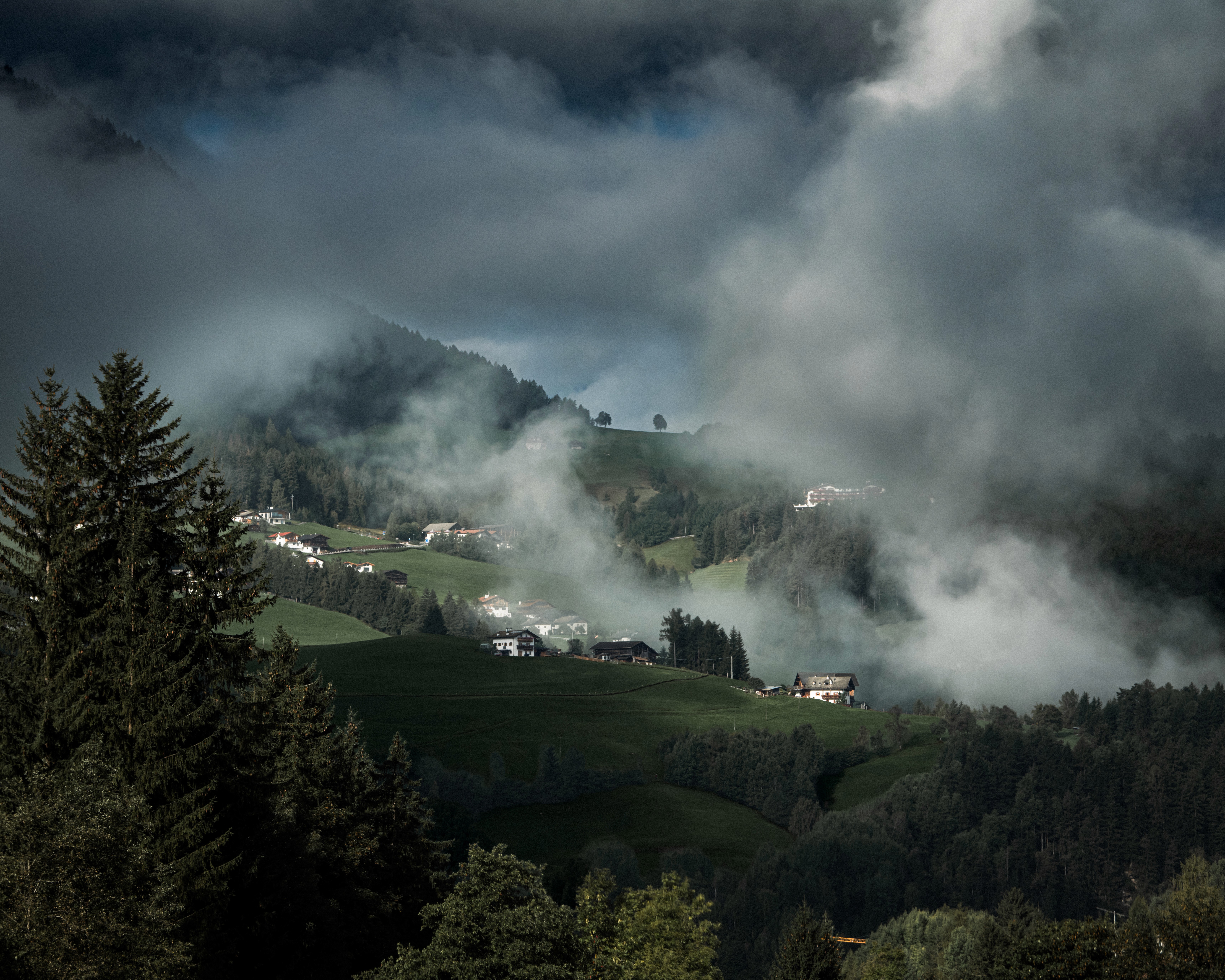 Layers of mist crossing a forested valley