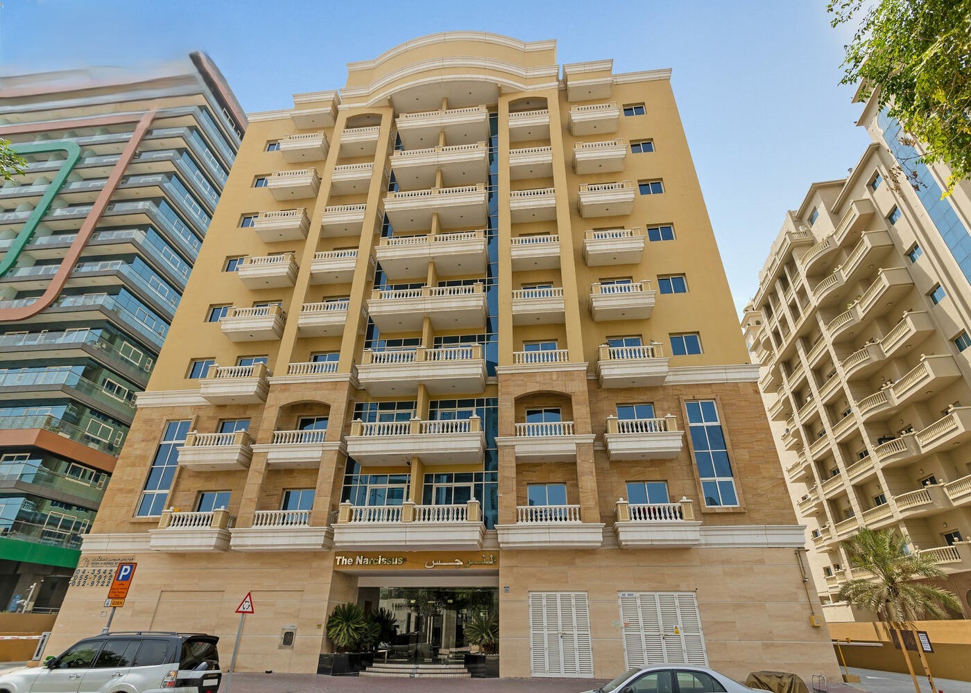 Entrance area of a high-rise tower. Real estate agent services available.
