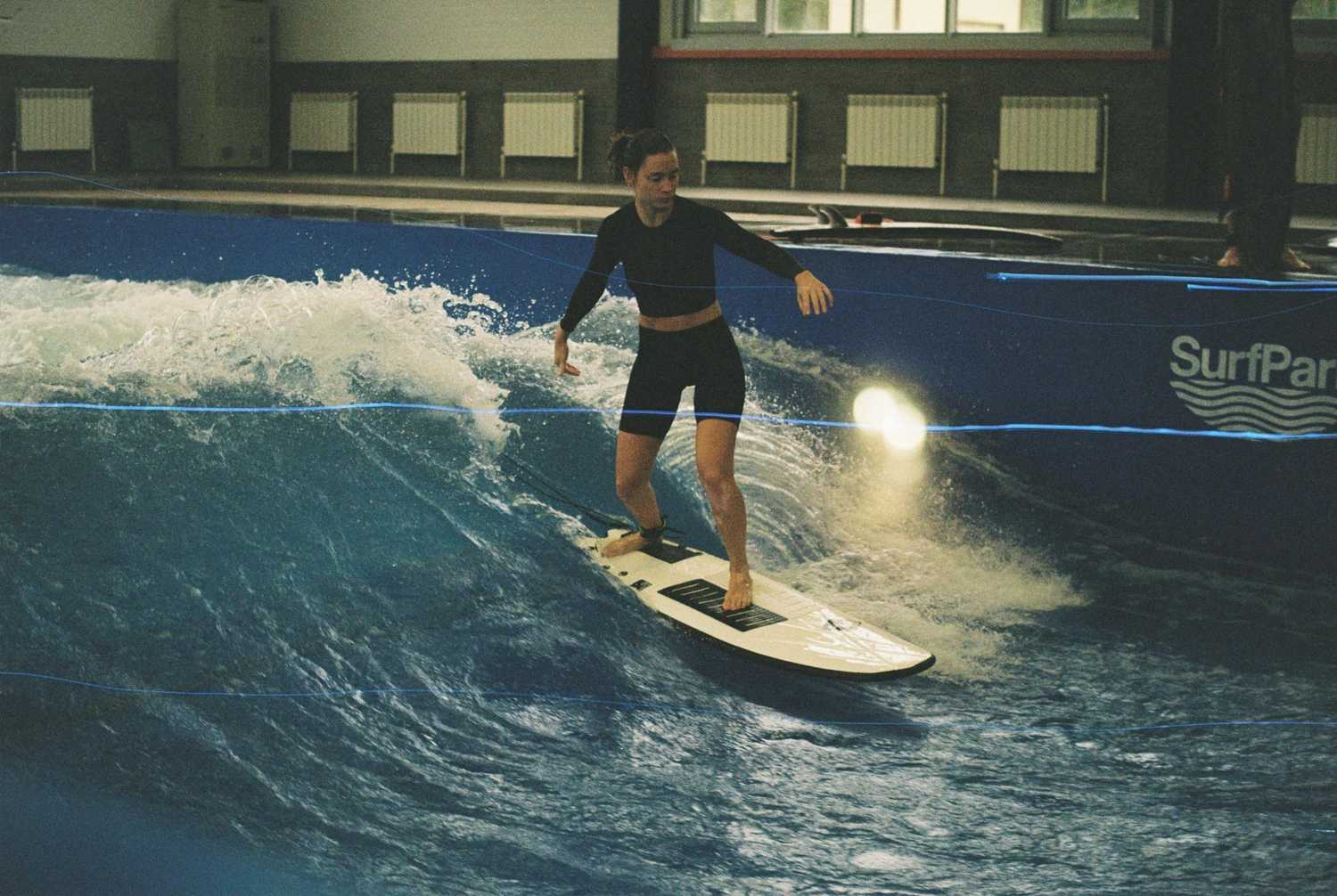 Surfer rides wave at indoor surf park – best-surfboard-for-beginners-a-complete-guide-to-choosing-your-first-board
