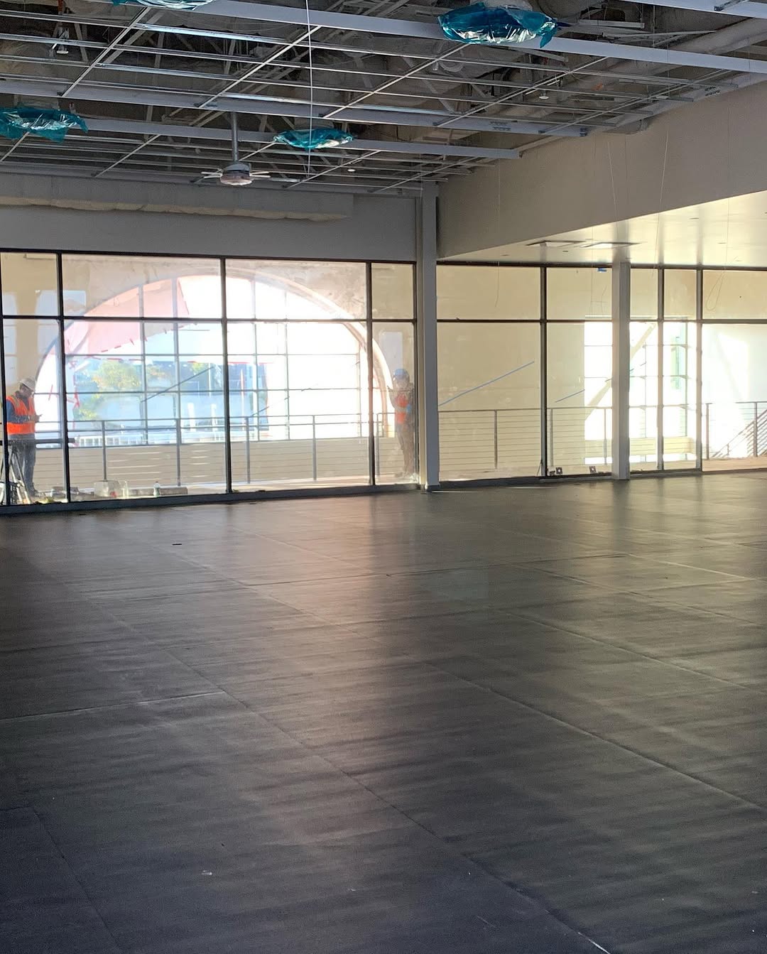 Finished rubber tile floor with daylight from the storefront glazing