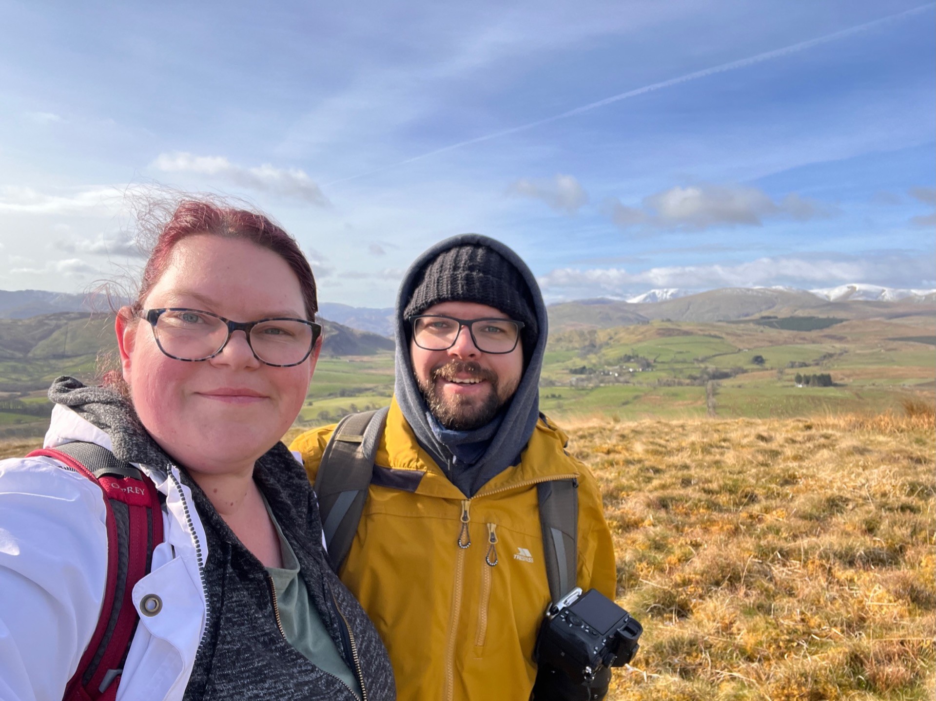 A selfie of Martin and April with the amazing view behind them of the mountains.