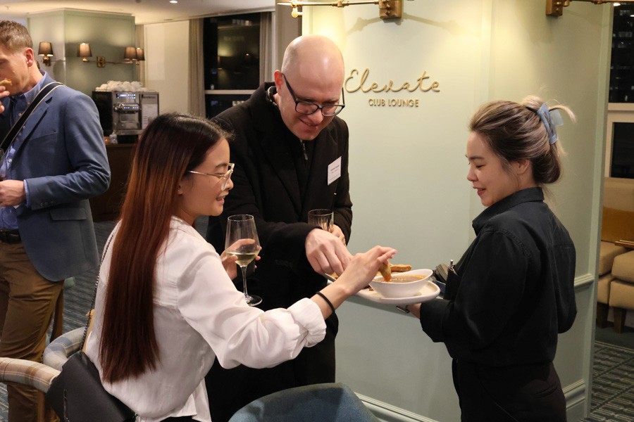 a man and a woman take appetisers from a waitress