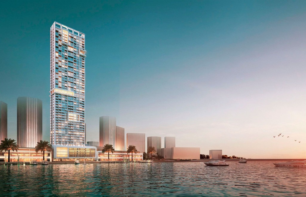 Anwa Aria by Omniyat under construction, showcasing a tower rising in the center of a body of water.
