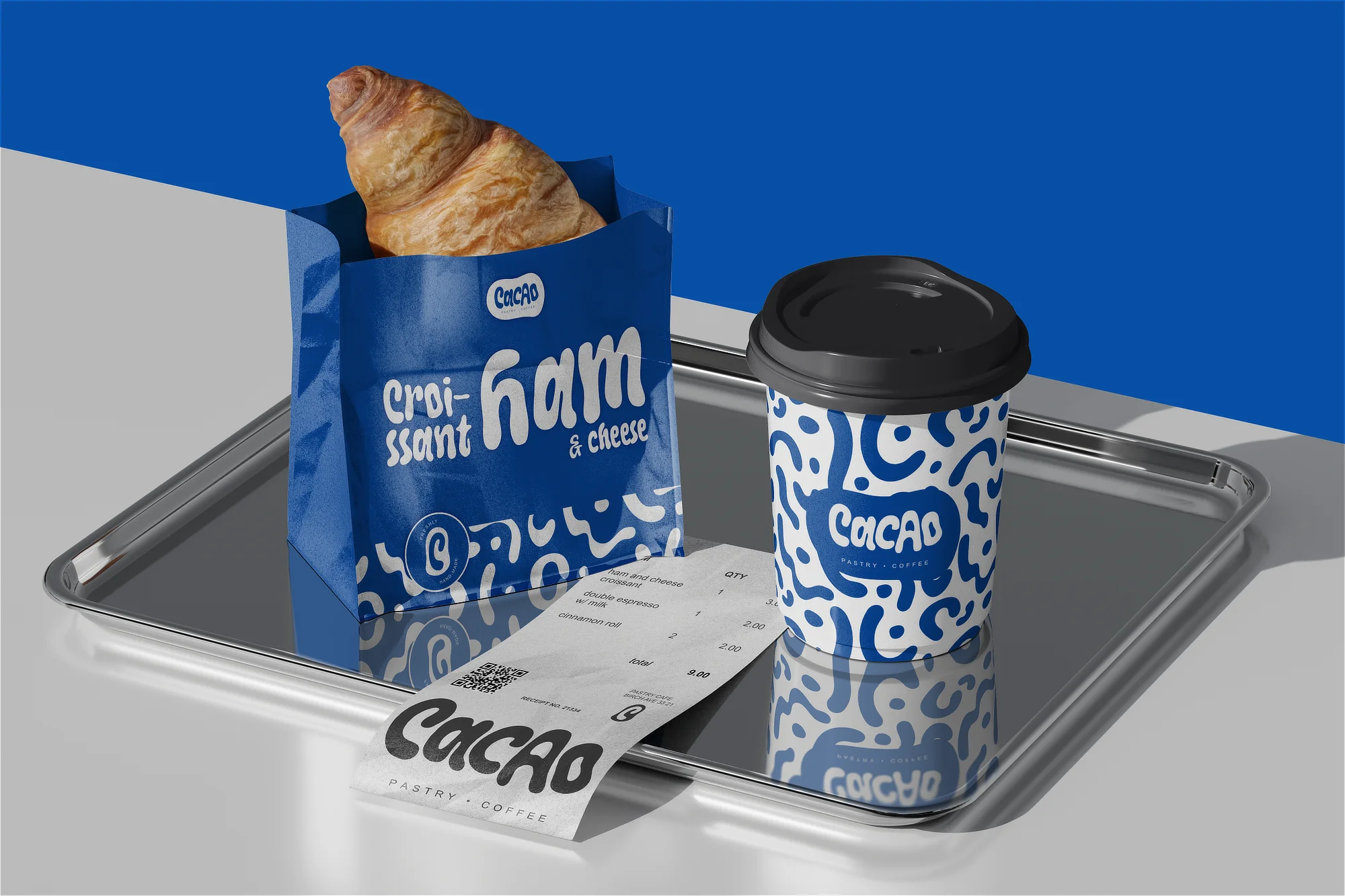 A takeaway paper coffee cup and a croissant in a branded pastry bag on a tray, next to a receipt featuring the Cacao logo, designed by Studio Liminal.