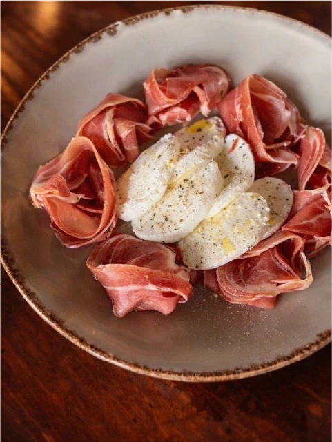 A plate of food and a glass of wine on a table