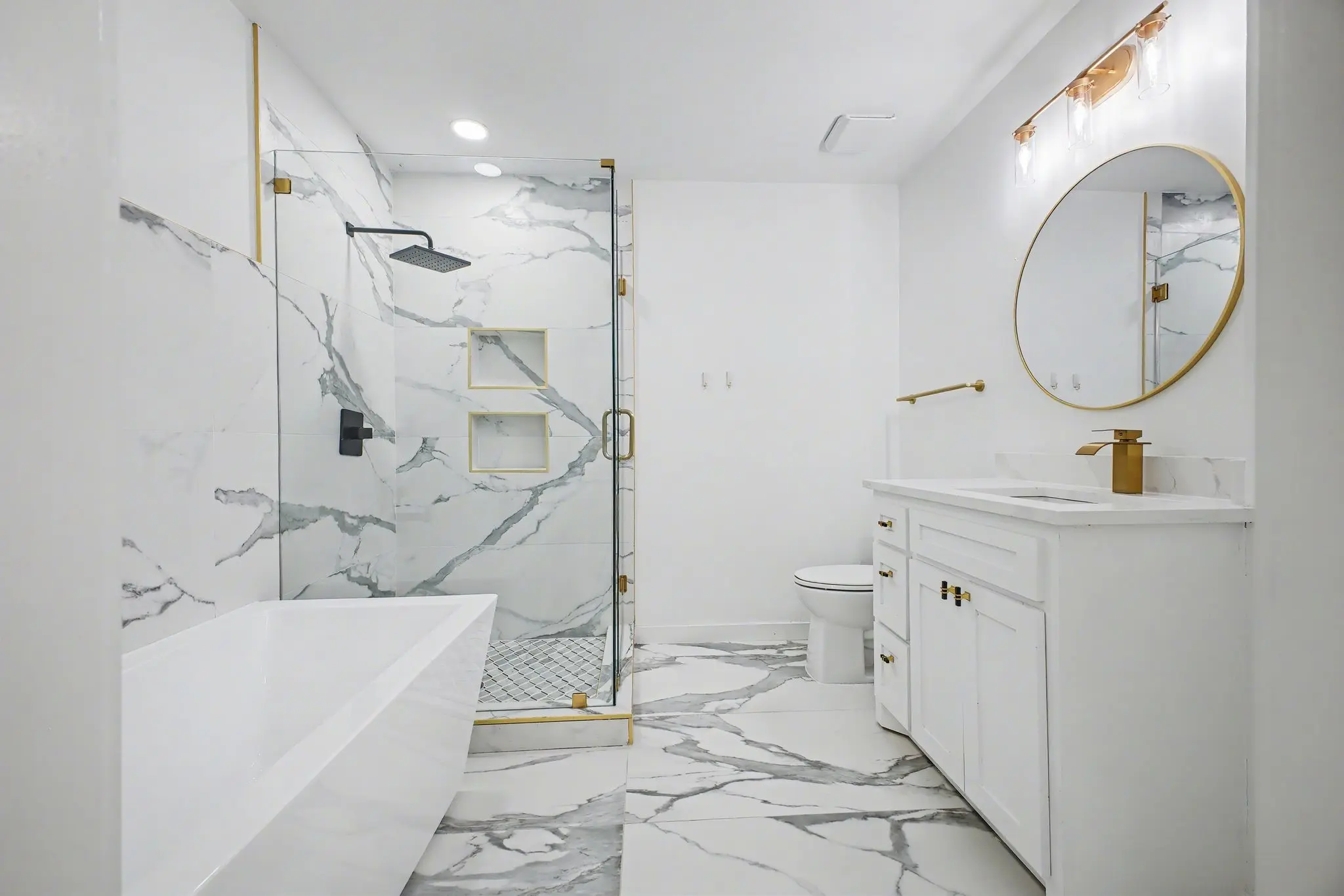 A light-filled fitness space with arched windows inside a coastal Mediterranean-modern villa, facing the ocean. 