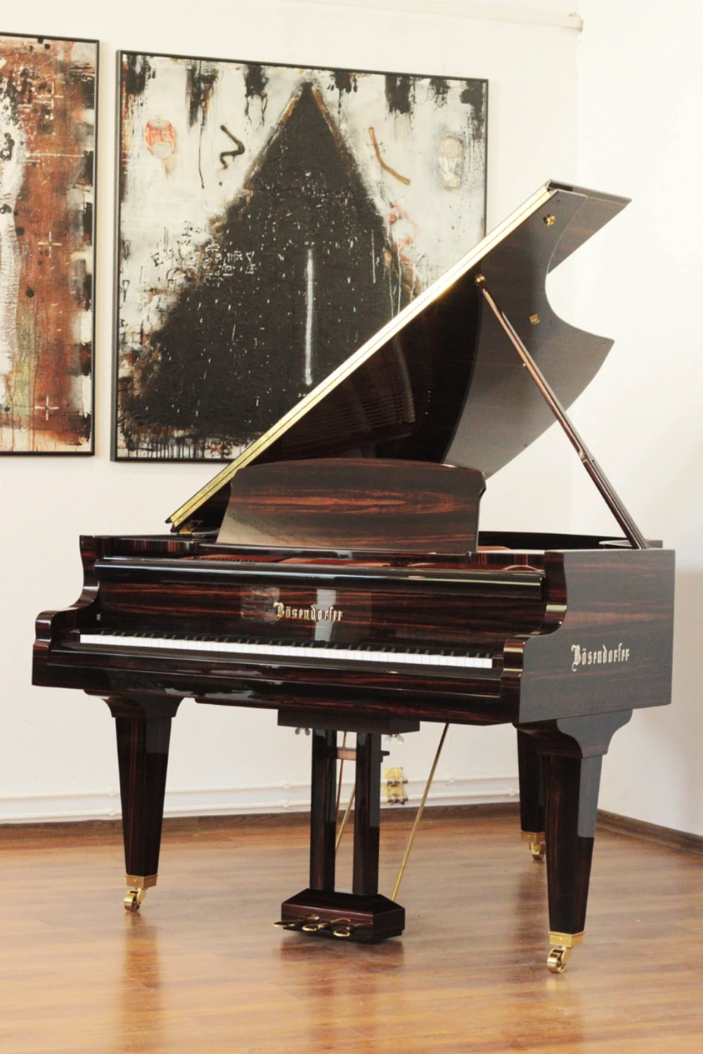 Elegant grand piano with a macassar finish, fully restored by Meyer Pianos.