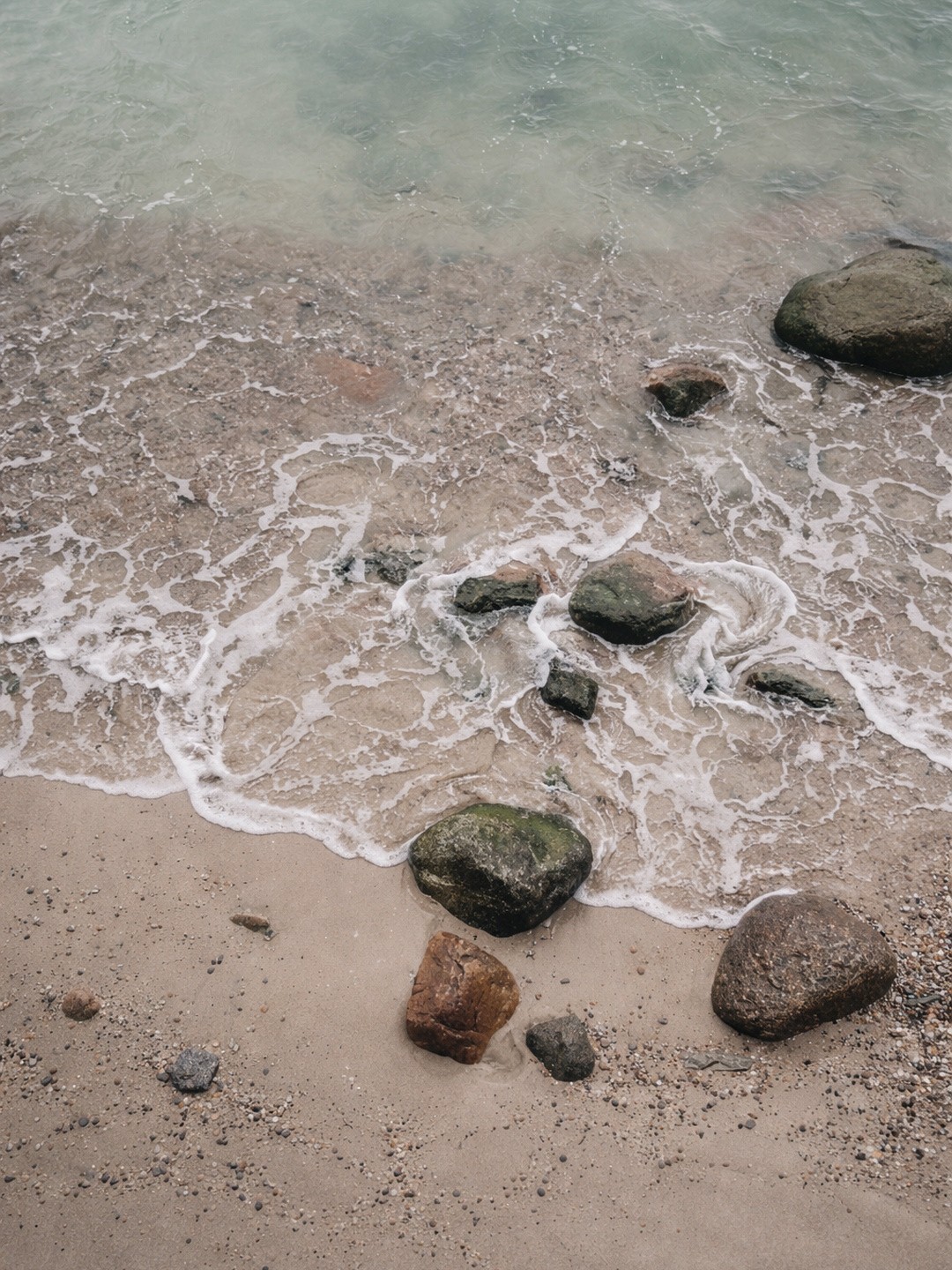 Pebbles on a shoreline, the natural inspiration behind Pebble Sconce