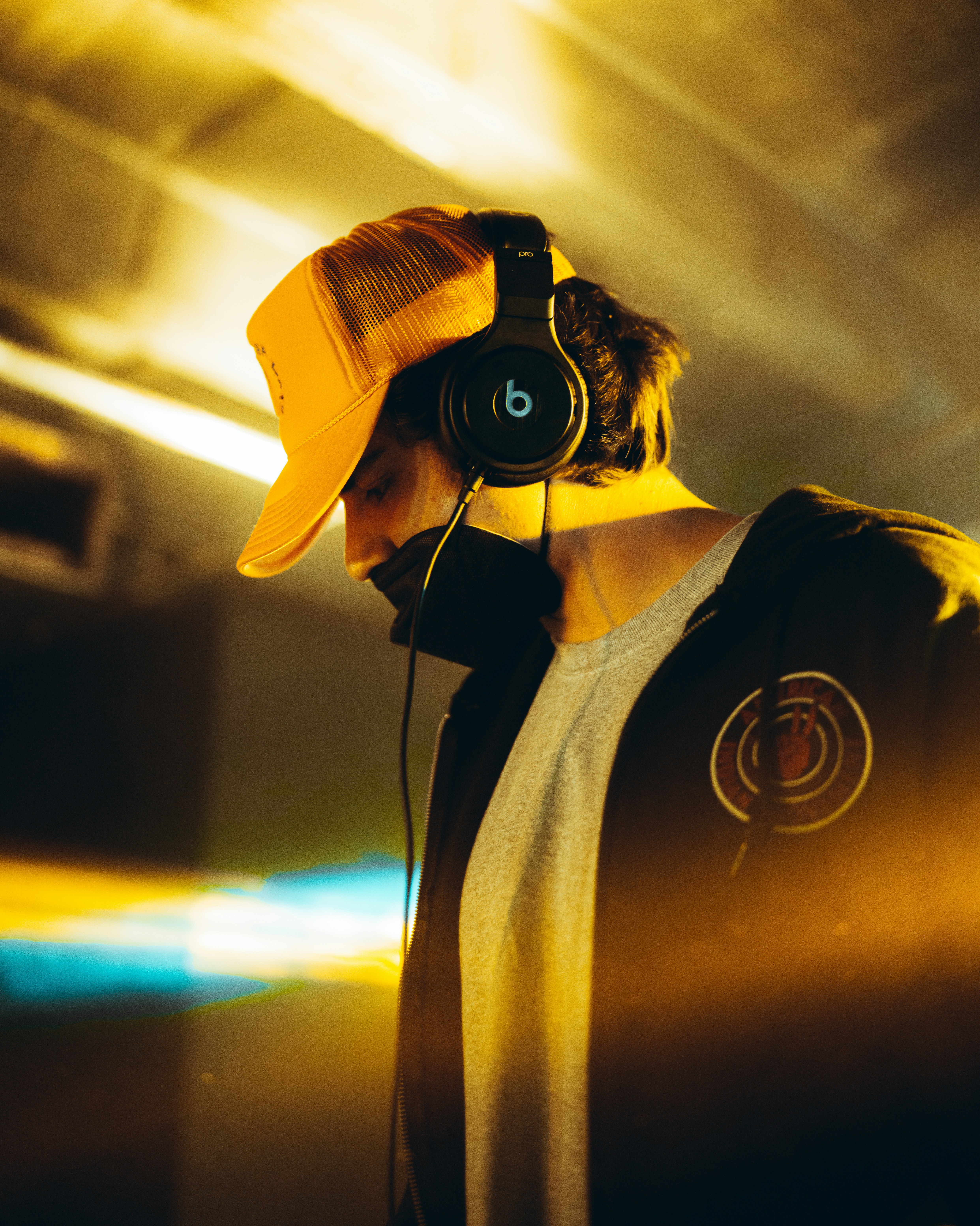 a man wearing headphones and a yellow hat