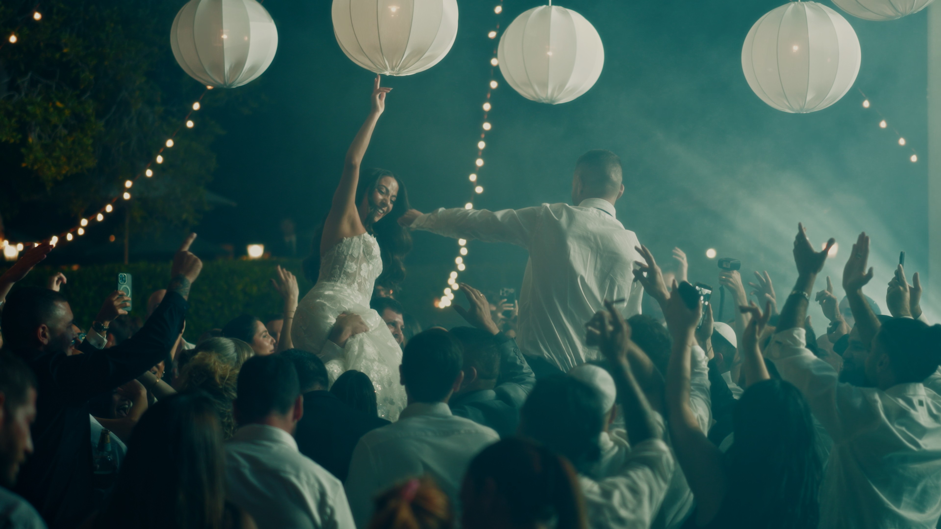 The bride is putting on her earrings.