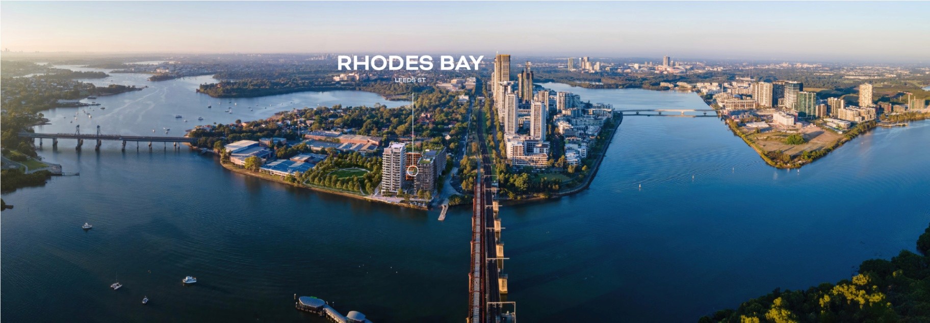 Aerial view of Rhodes Bay in Rhodes NSW highlighting river frontage, transport connections, and the central location near Sydney CBD.