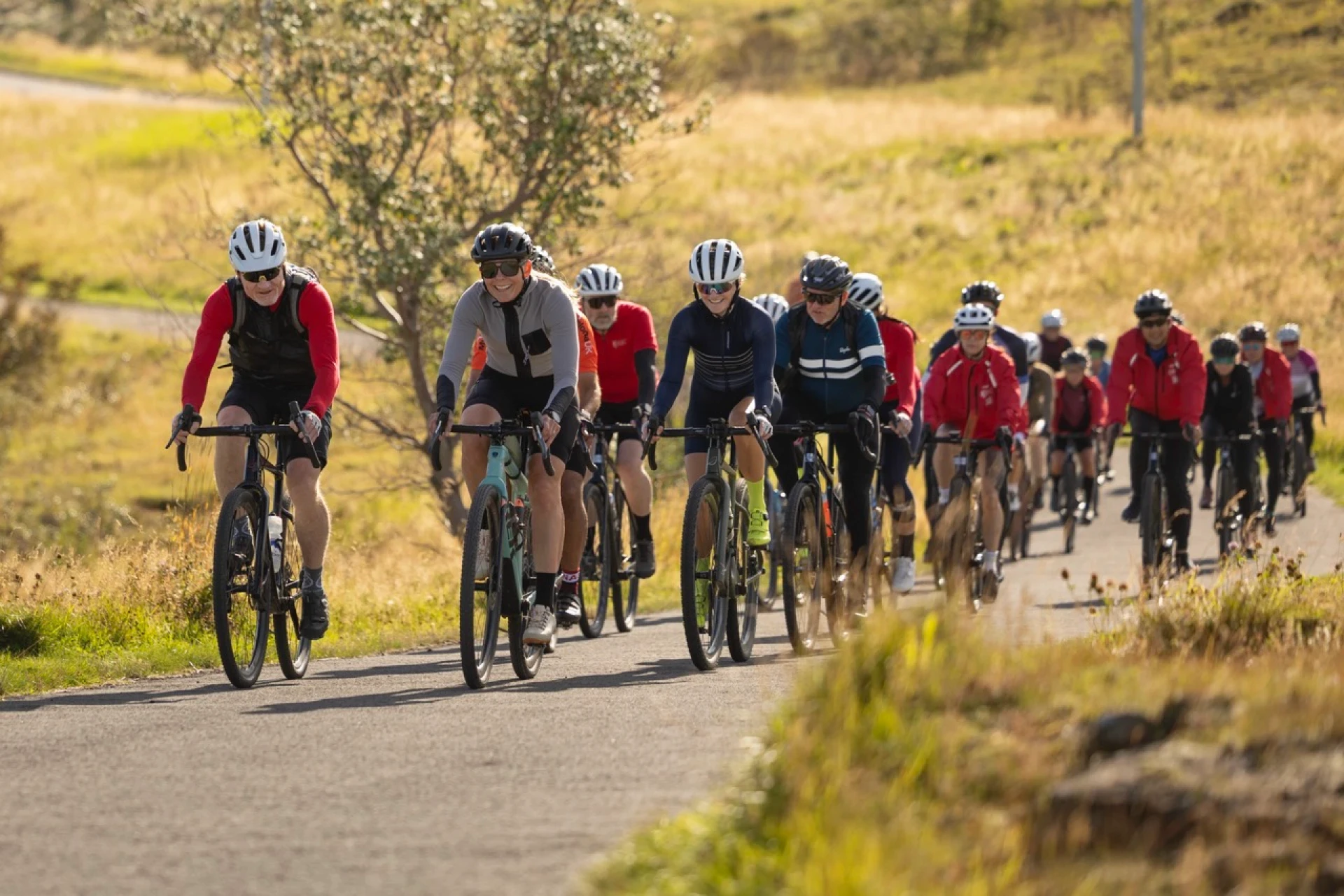 A group of gravel riders pedal towards camera