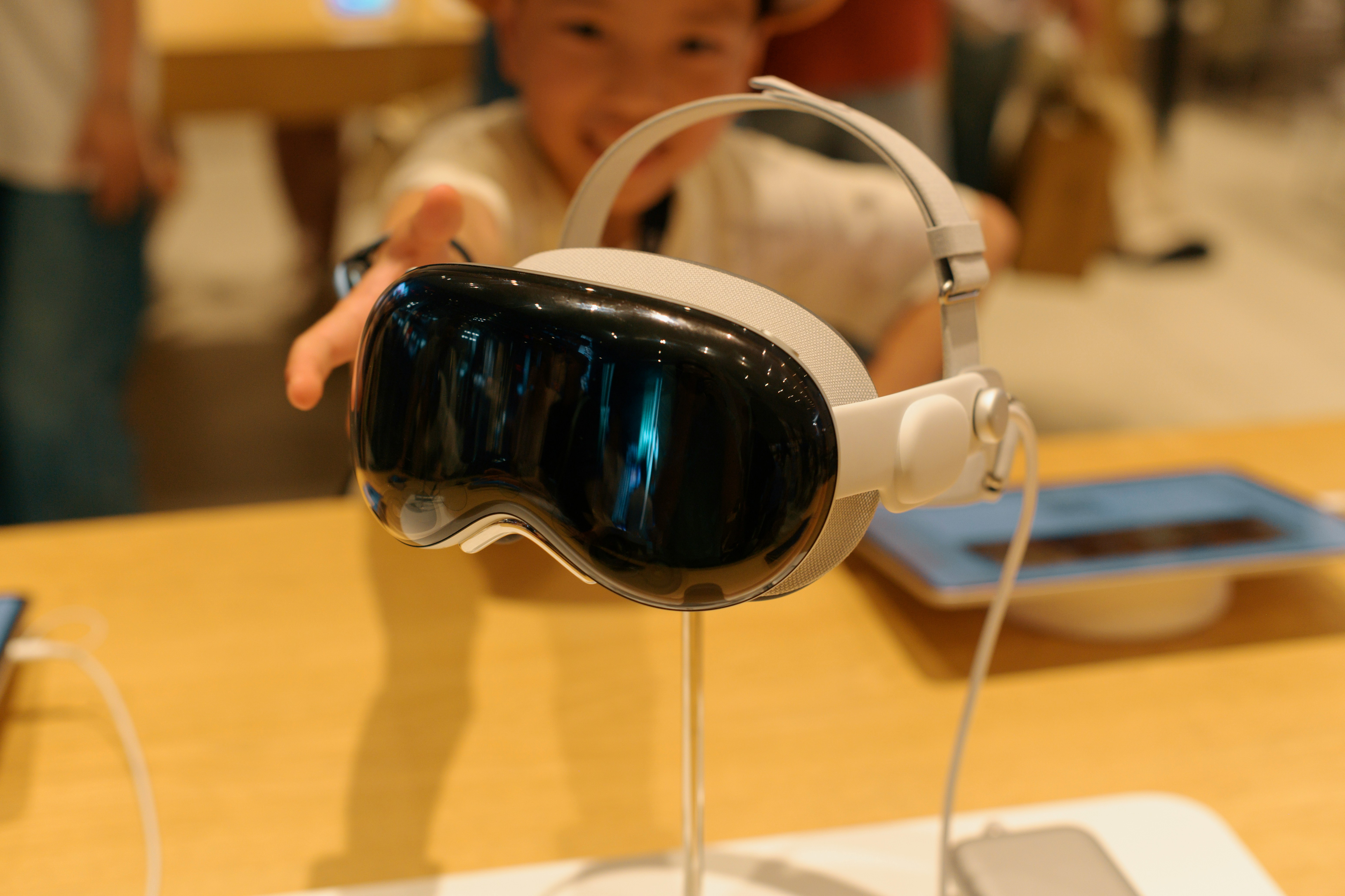 A baby wearing a pair of headphones on top of a table