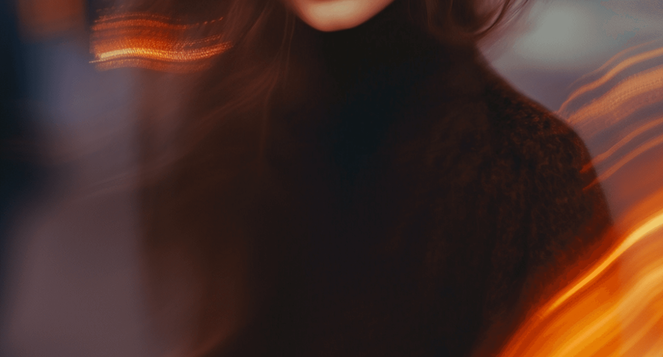 A woman with long hair poses against a backdrop of flames, highlighting her silhouette and the fiery scene behind her.