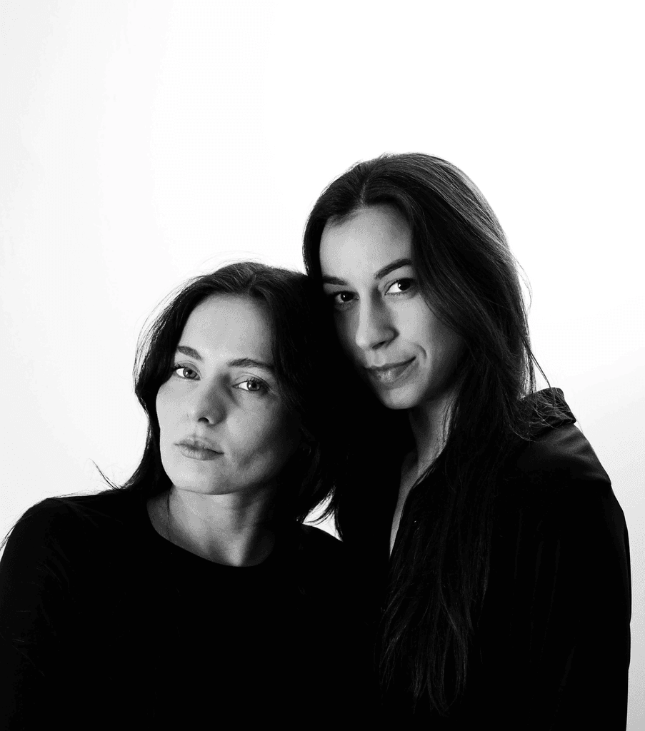 Two founders working side by side at a table.