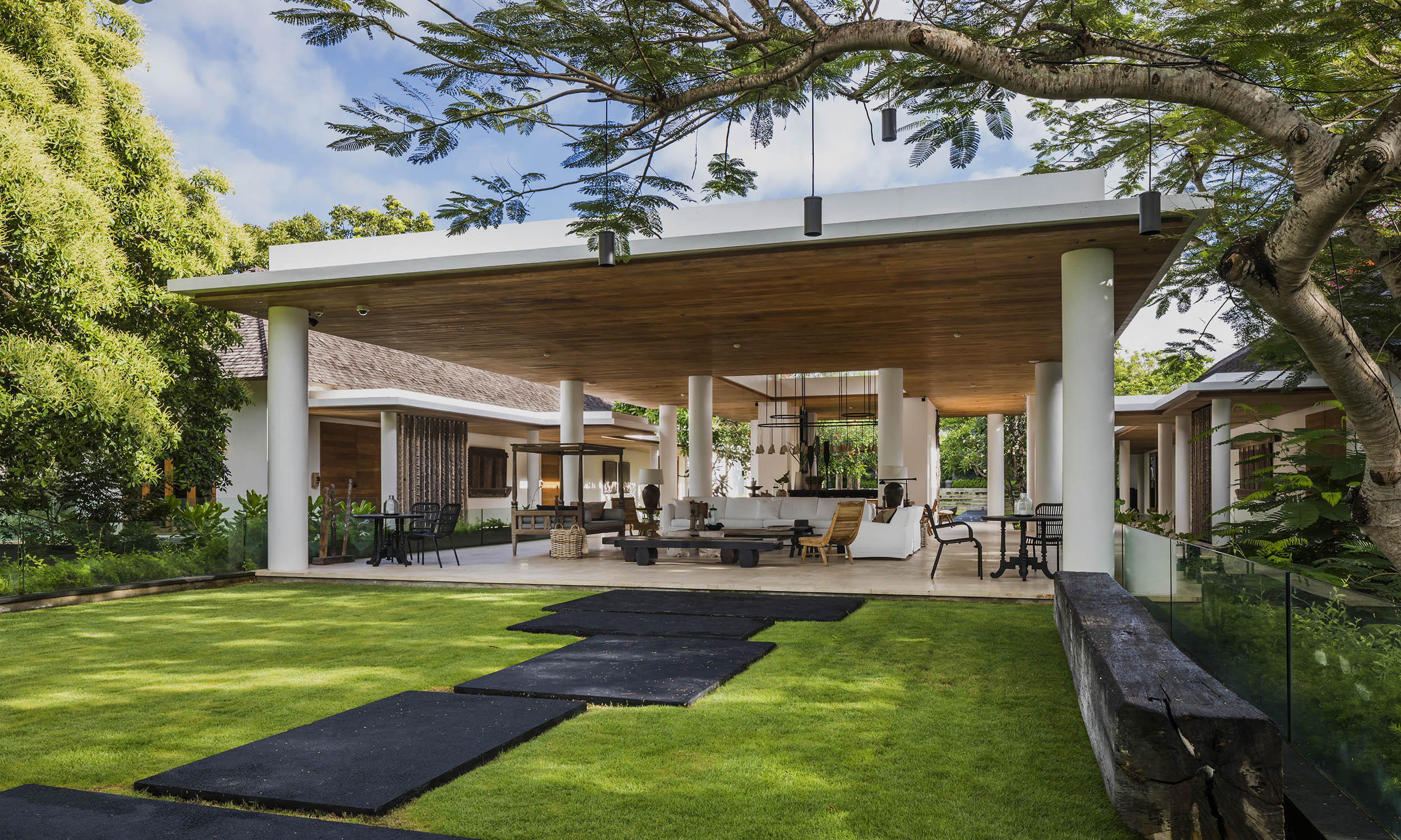 Open-concept luxury living space in Uluwatu with garden views, managed by our expert real estate team.