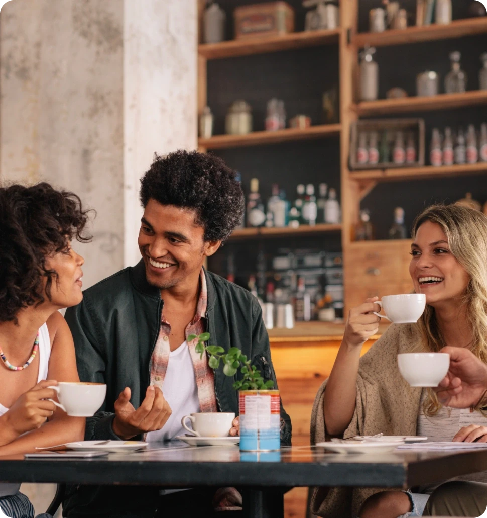 A dark cylindrical object on a wooden bar, with softly glowing lights in the blurred background.
