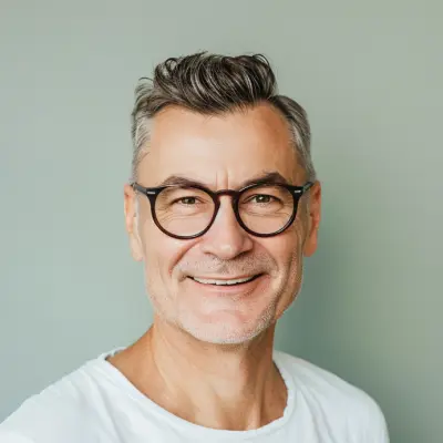 Mature man with glasses smiling, natural light, landscaping client testimonial portrait