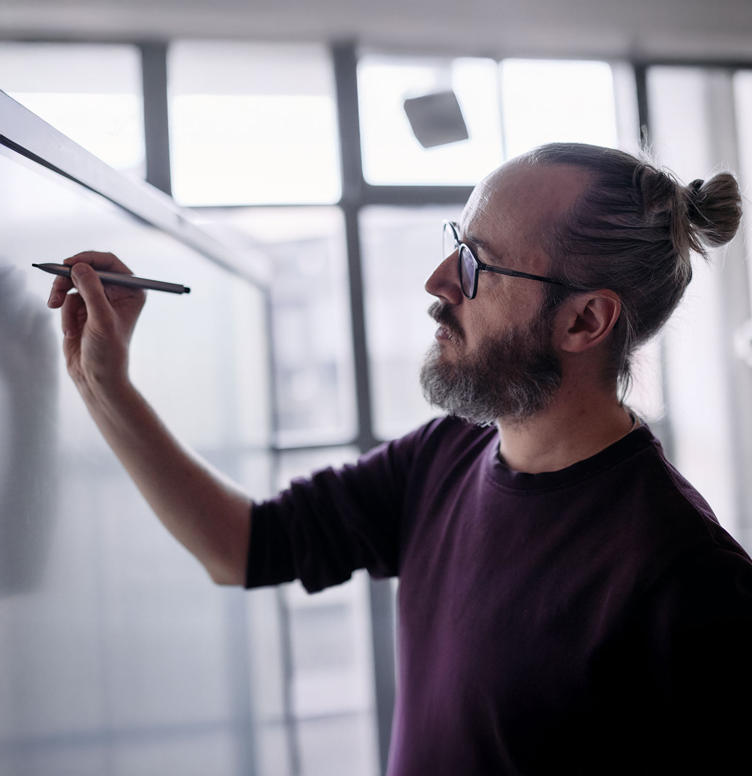 Valliance team member writing on a digital white board