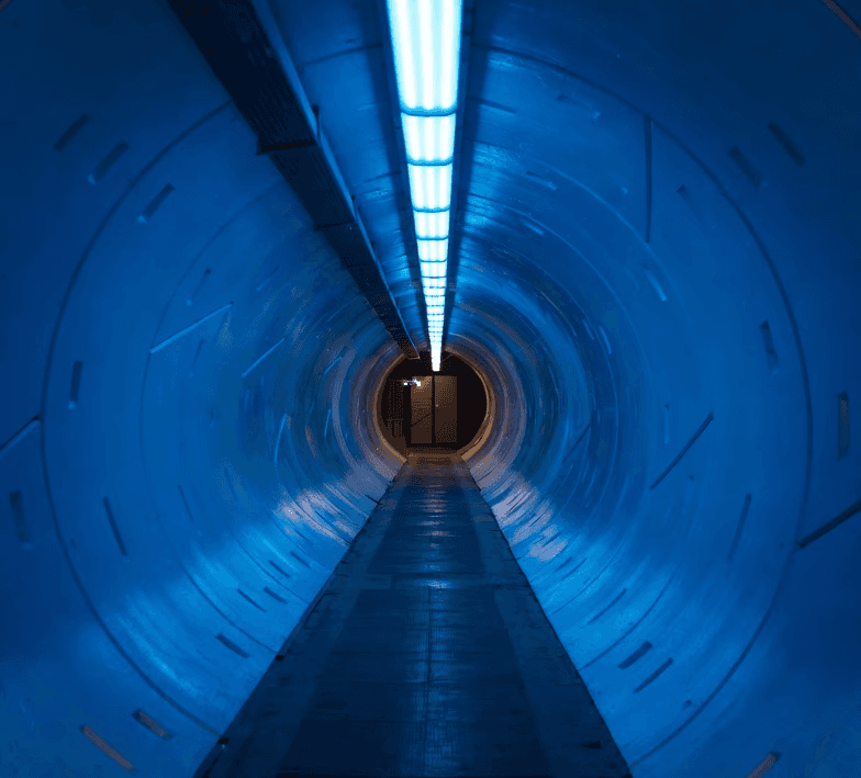 Illuminated tunnel with blue light at the end, representing the beginning of an AI transformation journey