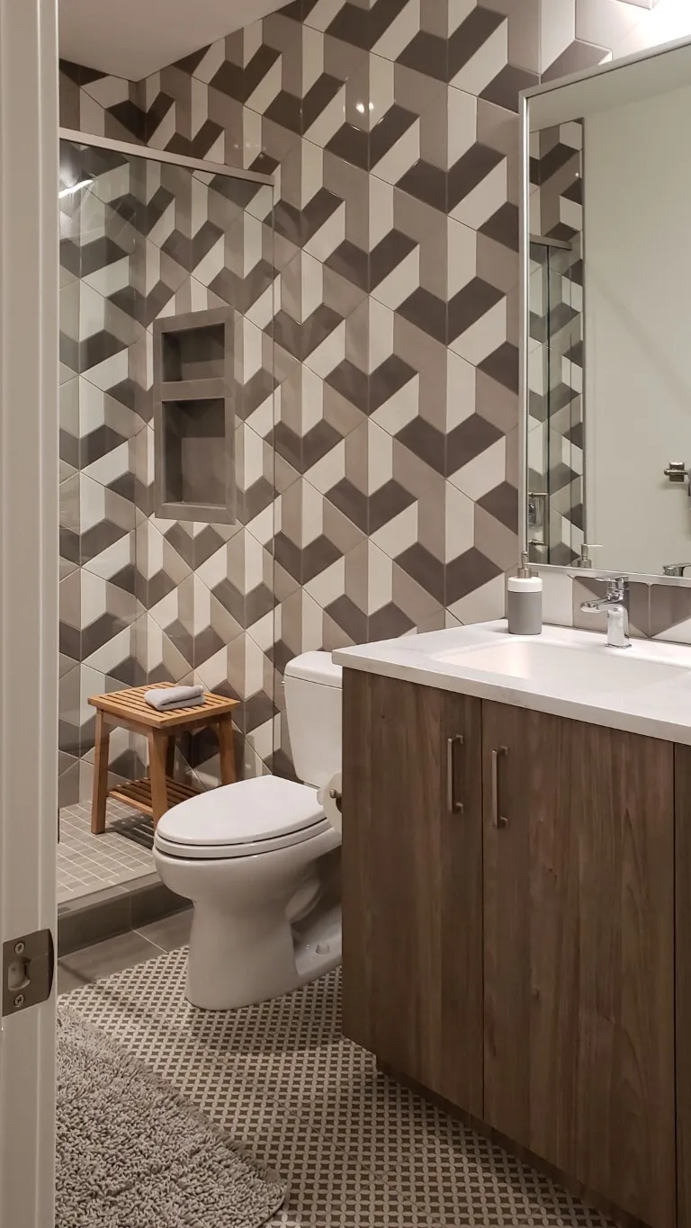 Image of KHD Homes luxury bathroom design with geometric tile, modern vanity, and spa-like primary ensuites amenities.