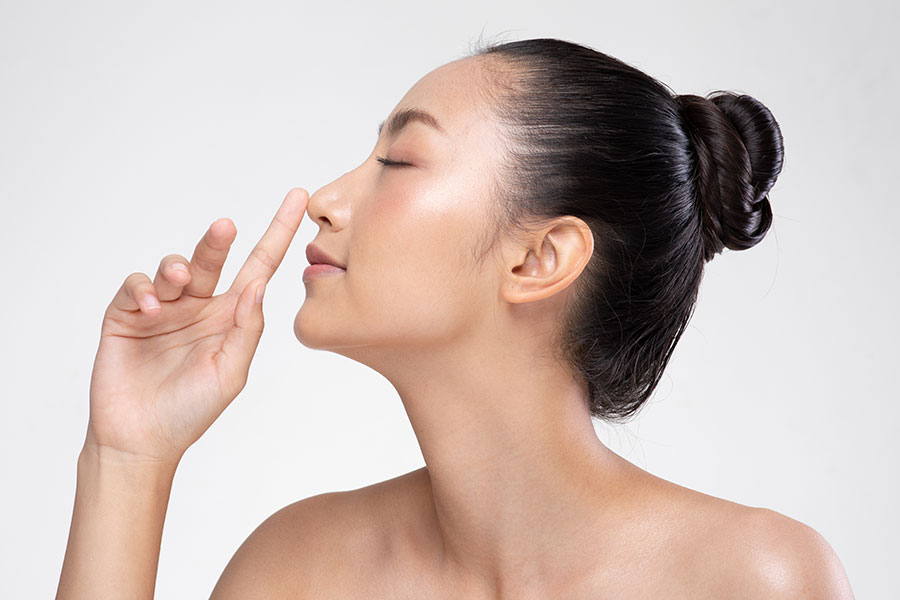 Side profile of a woman after nose filler treatment in Singapore