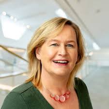 Natural rock arch framing desert landscape at sunset