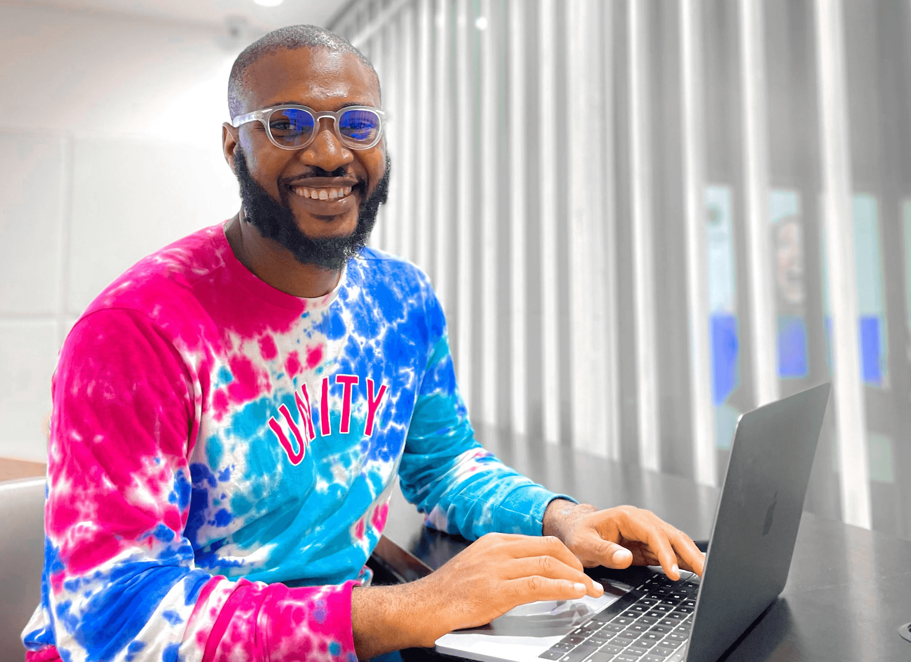 a person sitting at a desk with a laptop