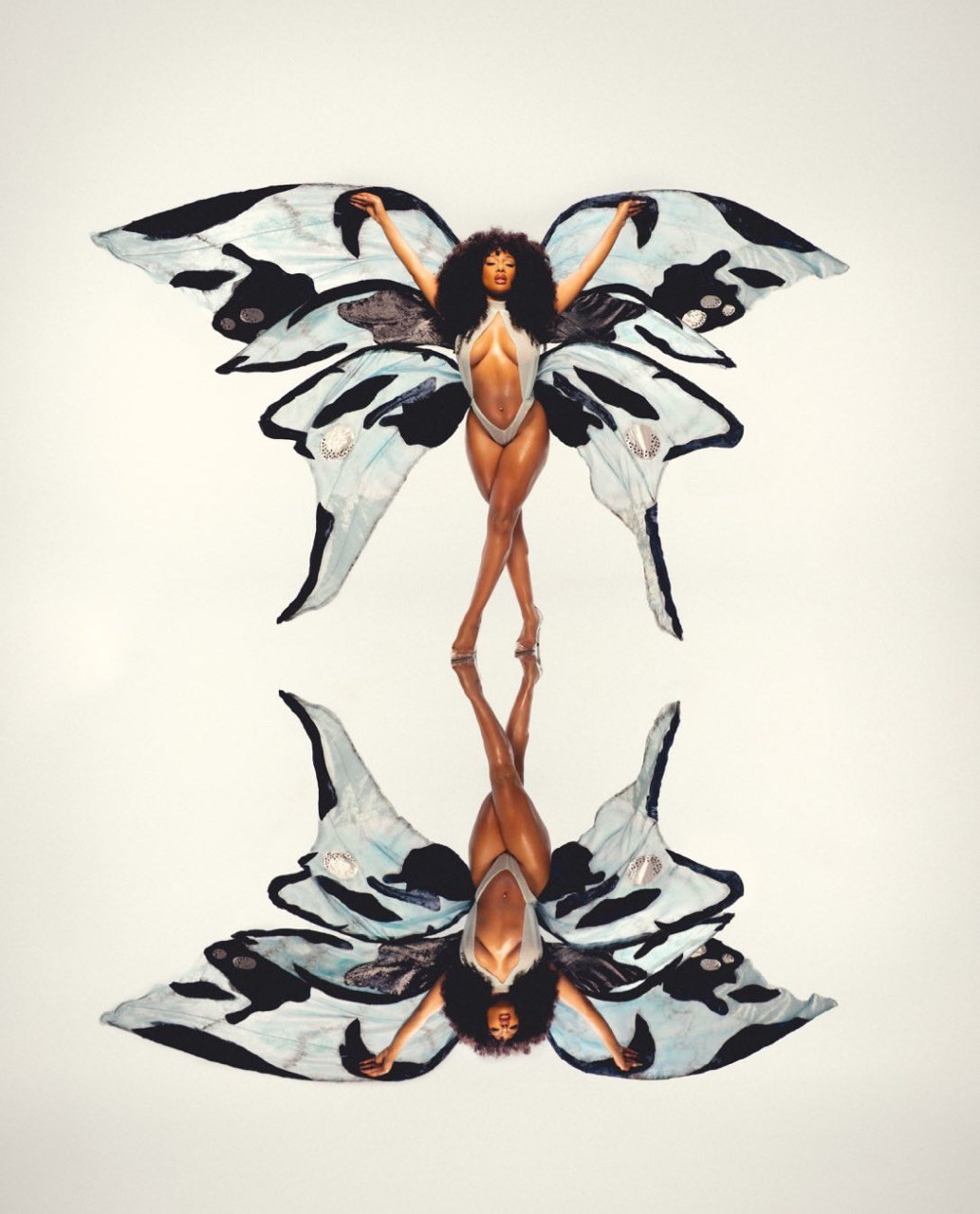 Megan Thee Stallion standing with custom butterfly wings