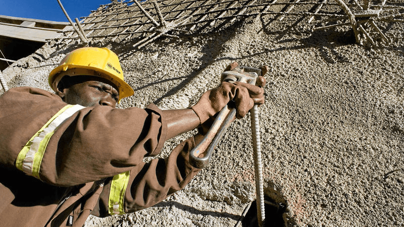 top view photography of four heavy equipment on quarry at daytime