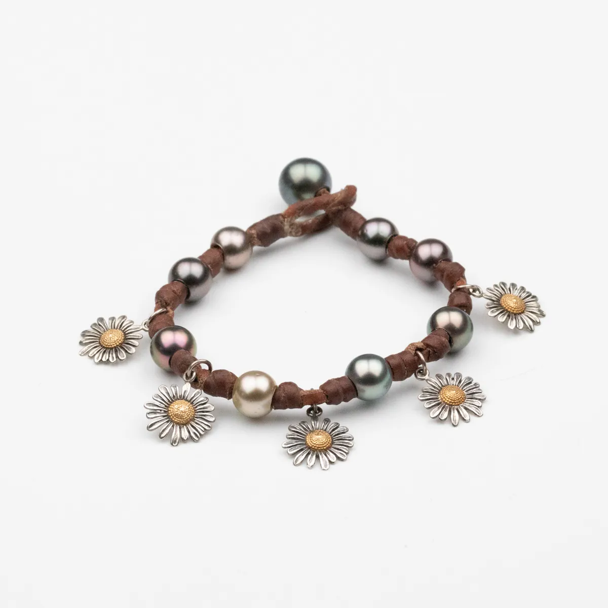 Tahitian Pearl leather bracelet with silver and gold flower charms on natural leather cord — Manos de Oro Saint Barth