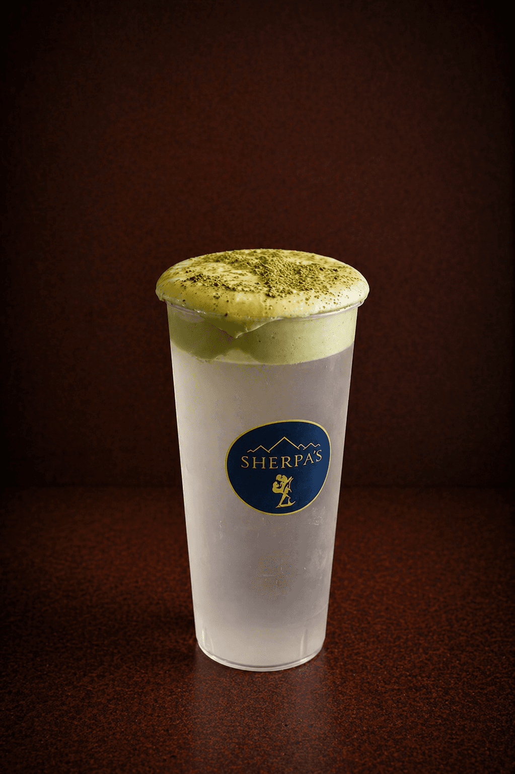 Coconut Matcha Cloud drink in a Café Sherpa's cup, Brookfield WI. Naturally sweet coconut water topped with smooth matcha sweet cream and a dusting of matcha powder.