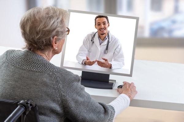 A woman sitting at a desk in front of a monitor