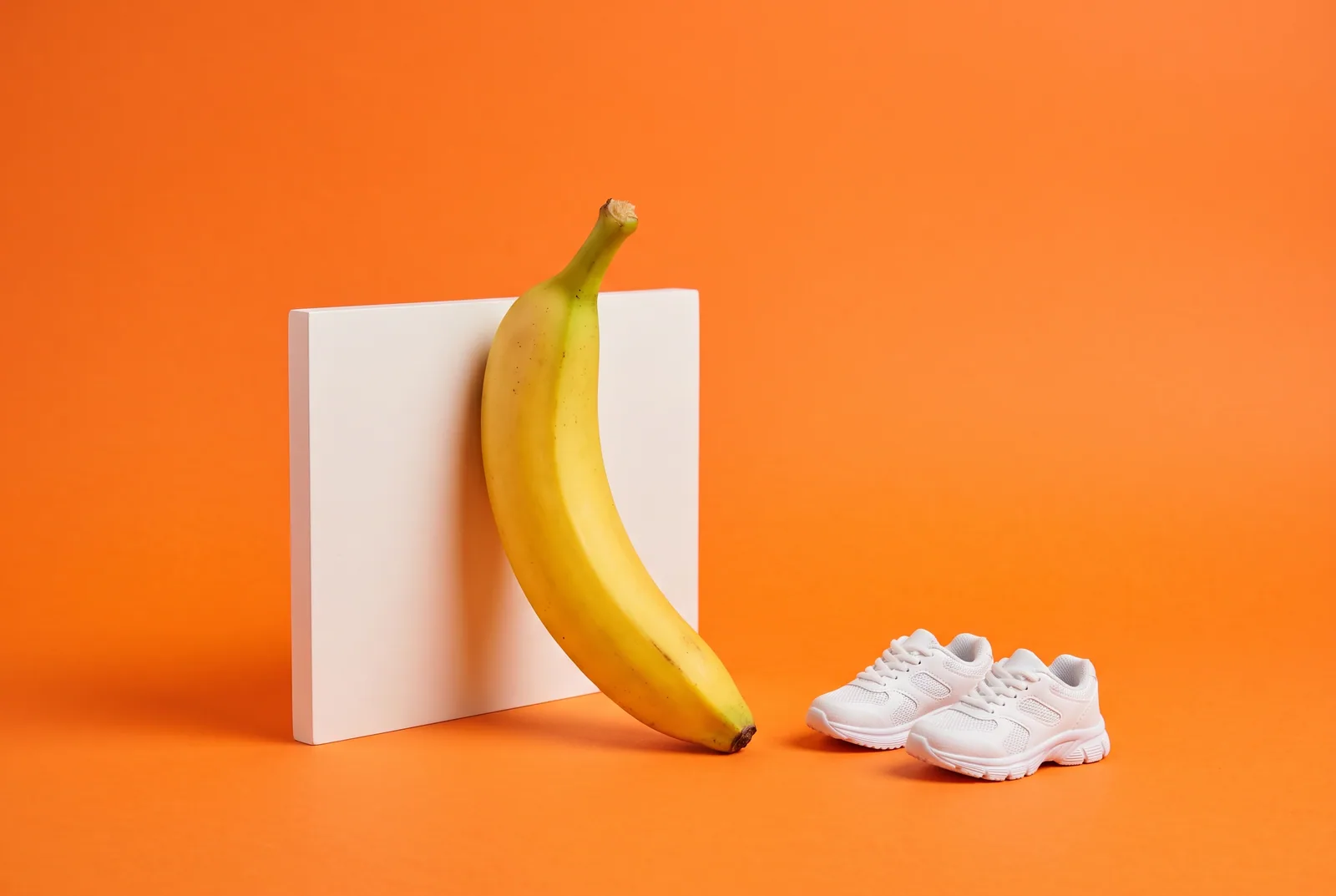 A banana facing a small white wall panel beside small sneakers, what to do when you block Pornhub and the urge is still there