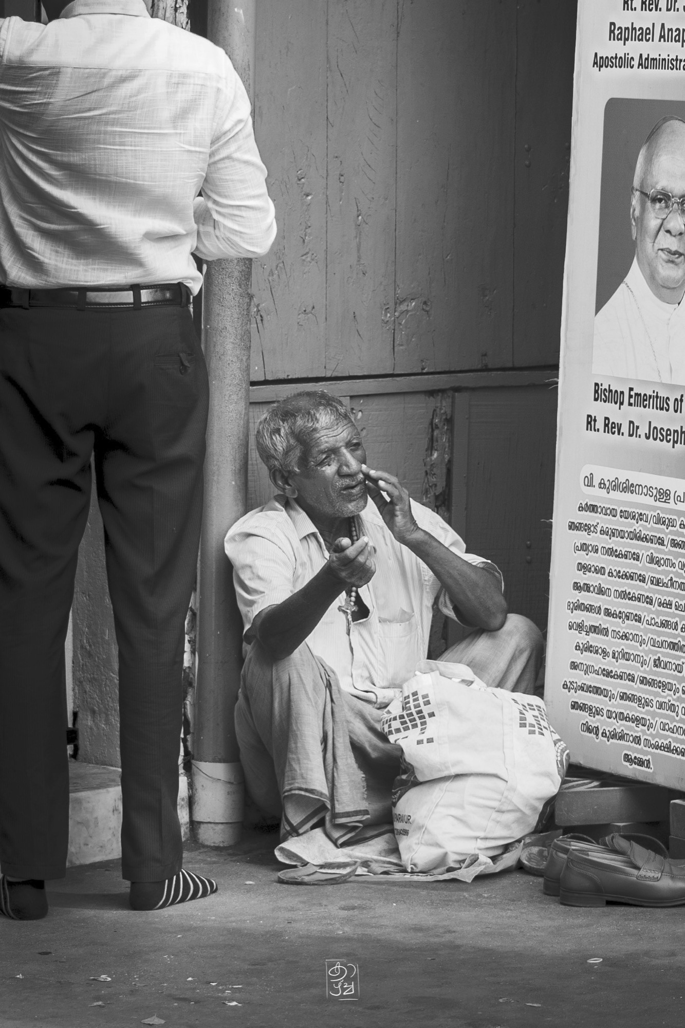 A man taking a moment beside the post