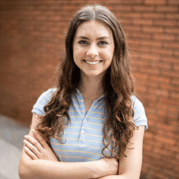 18 year old girl with arms crossed and smiling